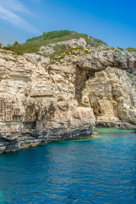 Corfu: Paxos Island Full-Day Cruise with Blue Caves - Entering the Blue Caves: emerald water and a fast photo moment